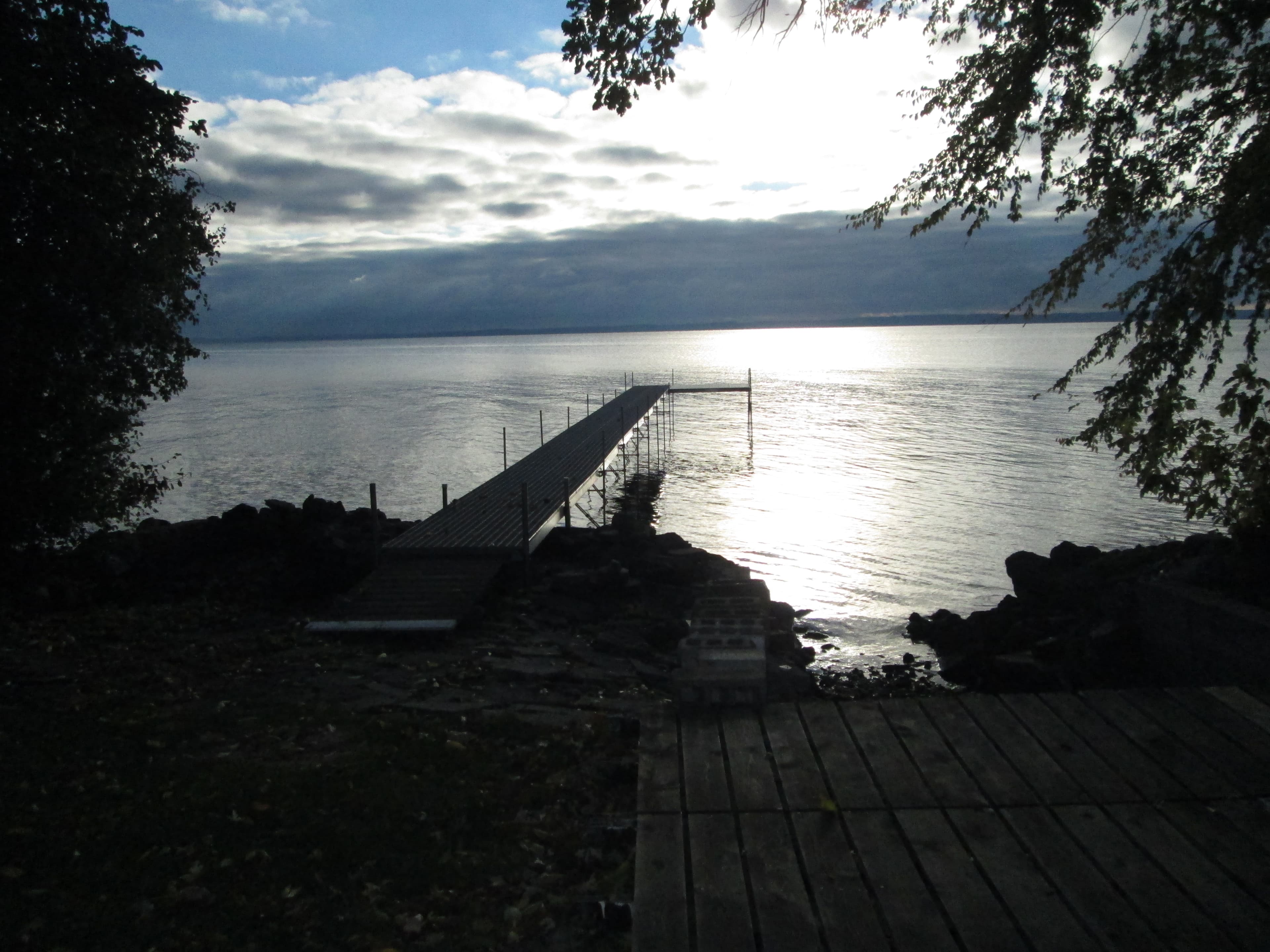 Custom dock installed by Piers 2U extending into a Wisconsin lake at sunset